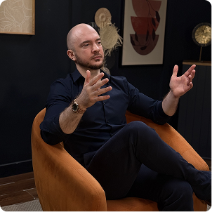 Mikail Gazibekov seated and speaking